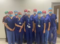 Brachytherapy Team wearing blue theatre scrubs, caps and facemask