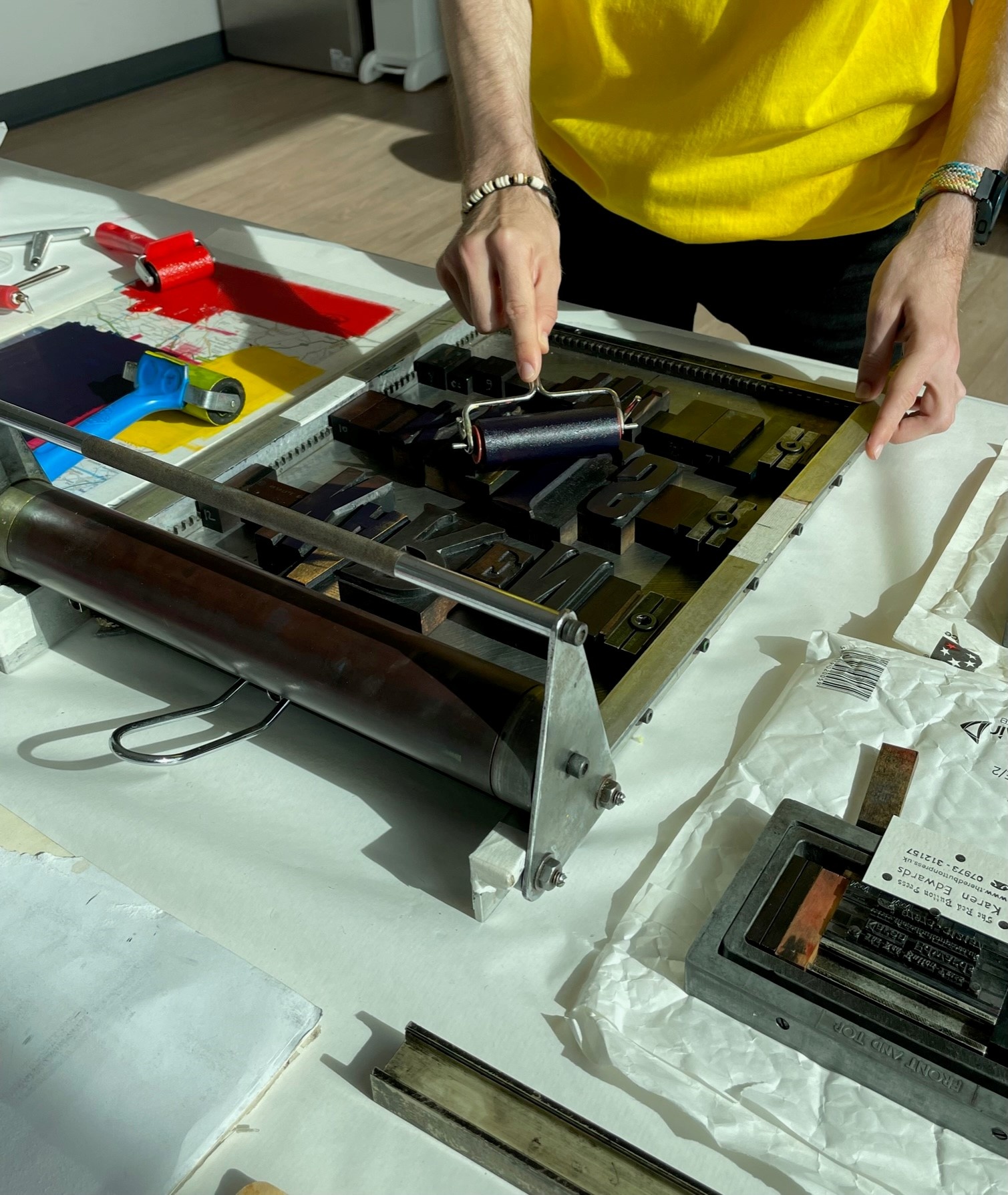Close-up of someone using a screenprinting machine to create art