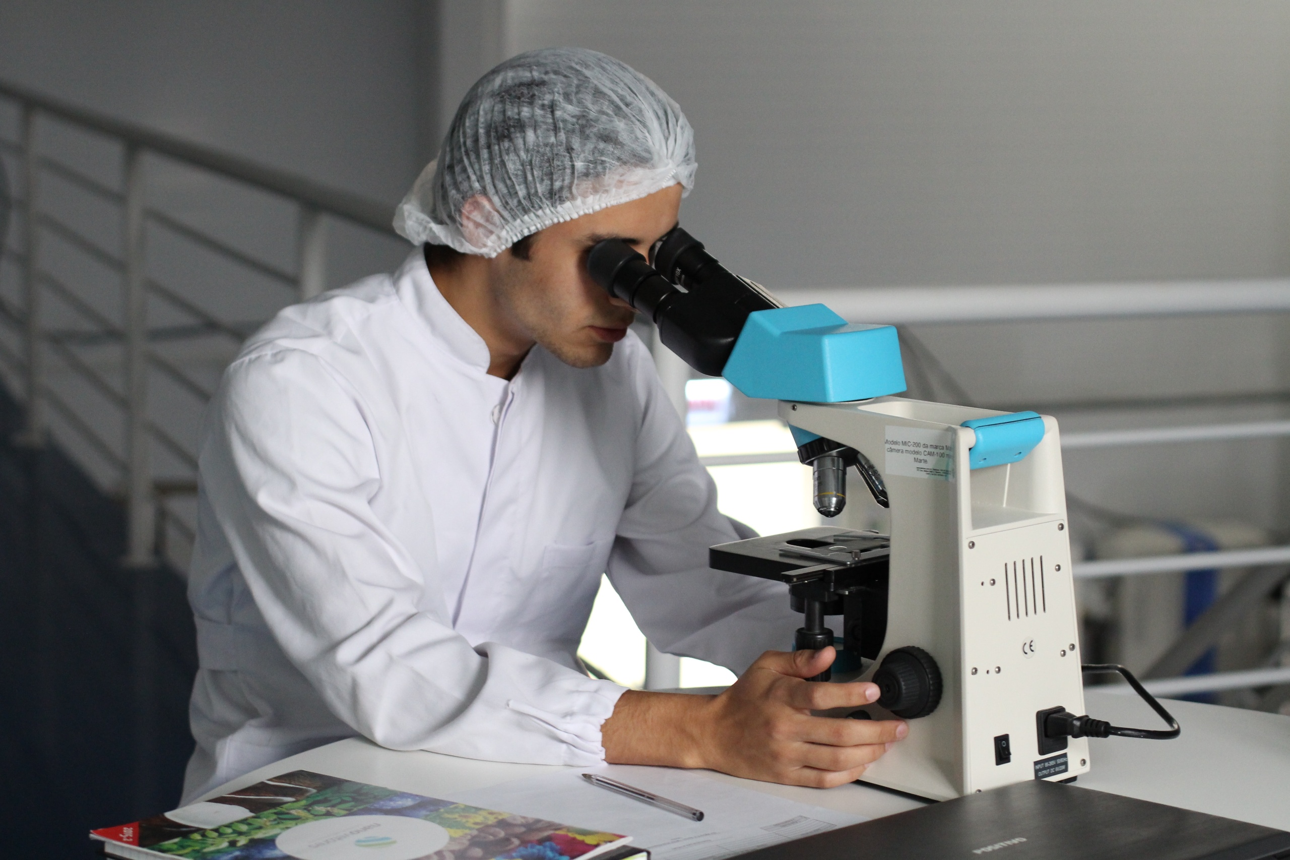Researcher looking through a microscope