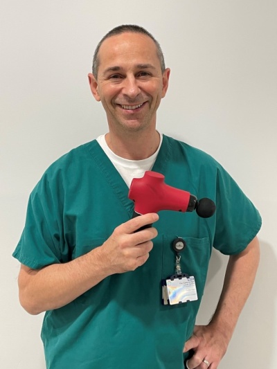 Dr Seamus Coyle with a massage gun.jpg