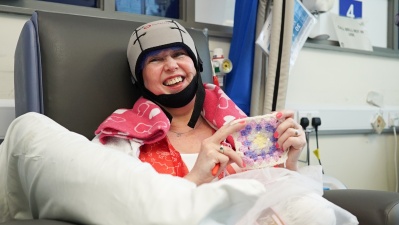 Woman wearing cool cap for scalp cooling during chemotherapy treatment